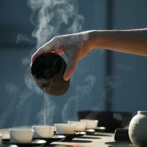 person pouring hot water on white cup